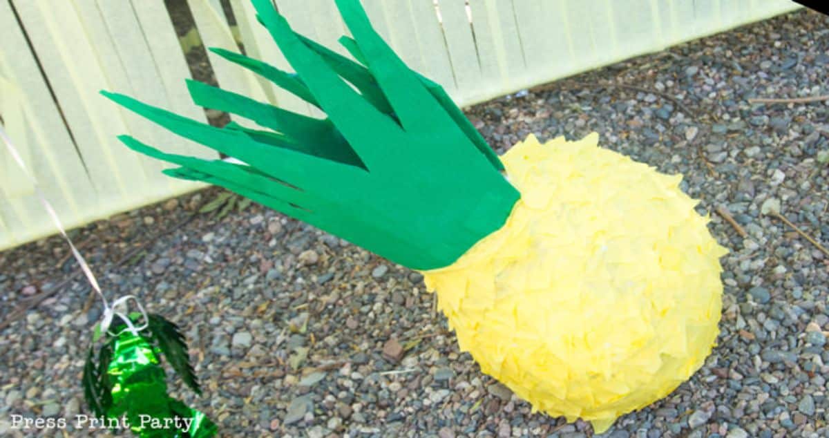Pineapple pinata outdoor on a gravel.