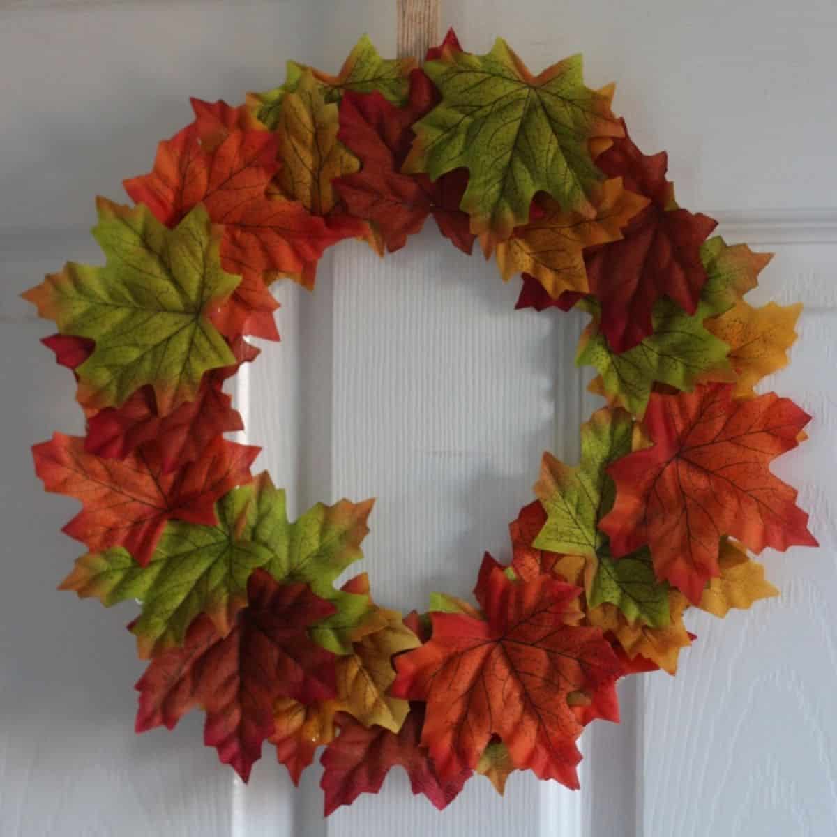 Paper plate Autumn/Fall leaf wreath hanging on a door.