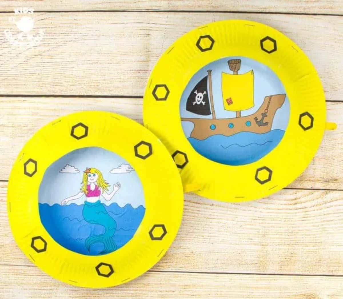 Papaer plate porthole craft on a wooden table.