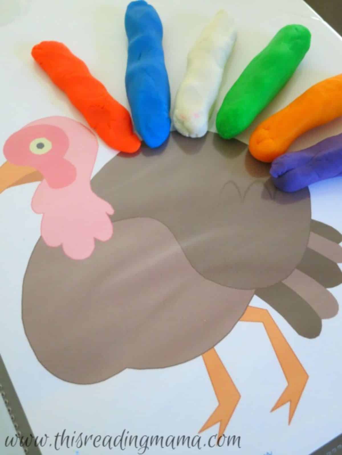 DIfferent colors of playdough on a turkey portrait.