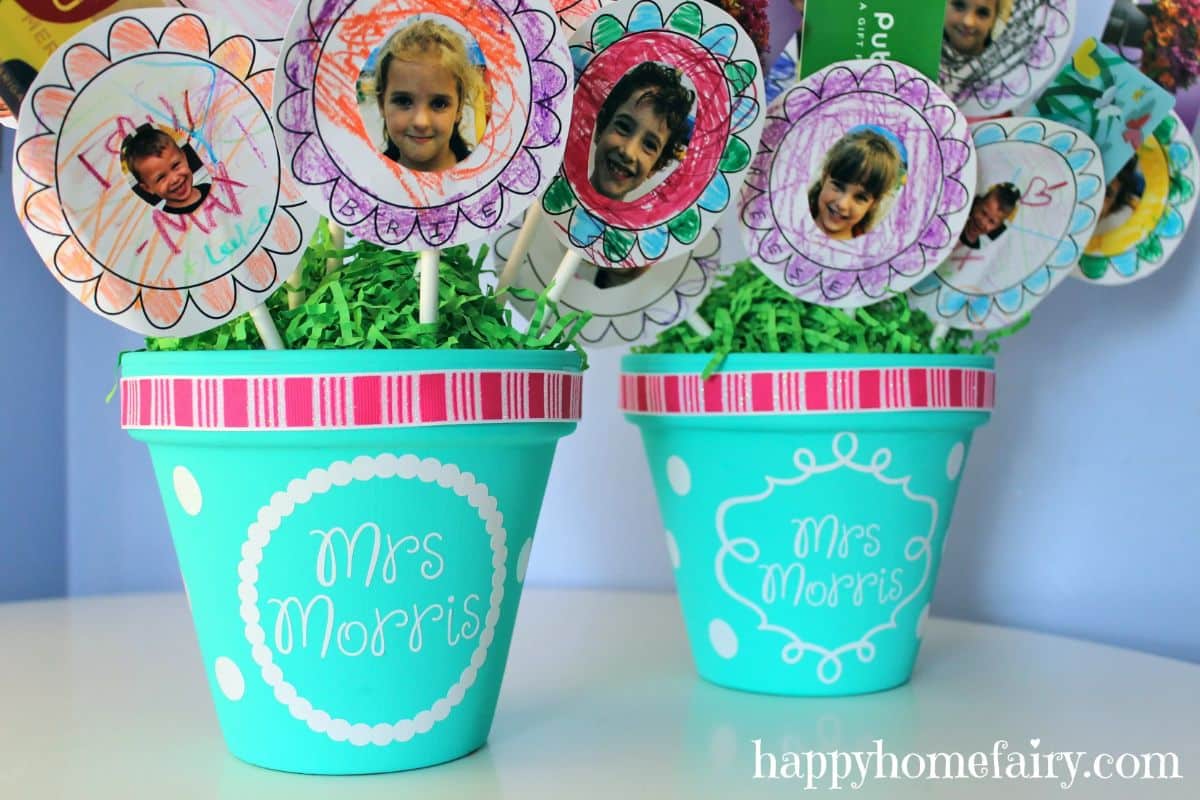 Flower cards with photos of kids sticked in a blue pots.