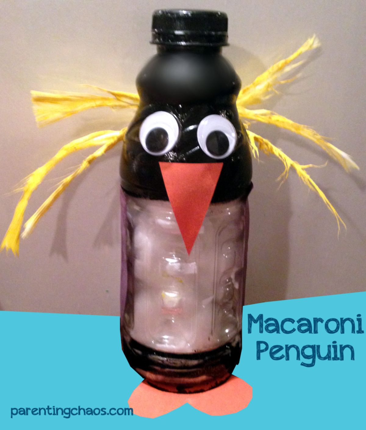 The text reads "Macaroni Penguin" the image is of a water bottles painted black, with googly eyes, orange beak and feet and yellow string as hair
