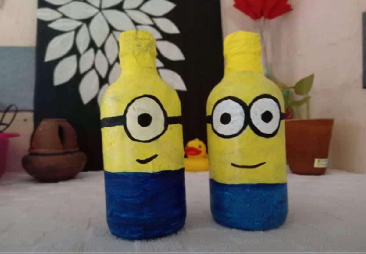 Two water bottles decorated to look like minons
