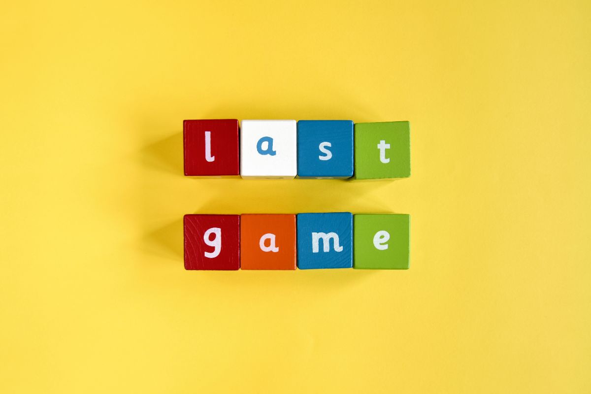 on a yellow background are building blocks with letters on, spelling out "Last game"