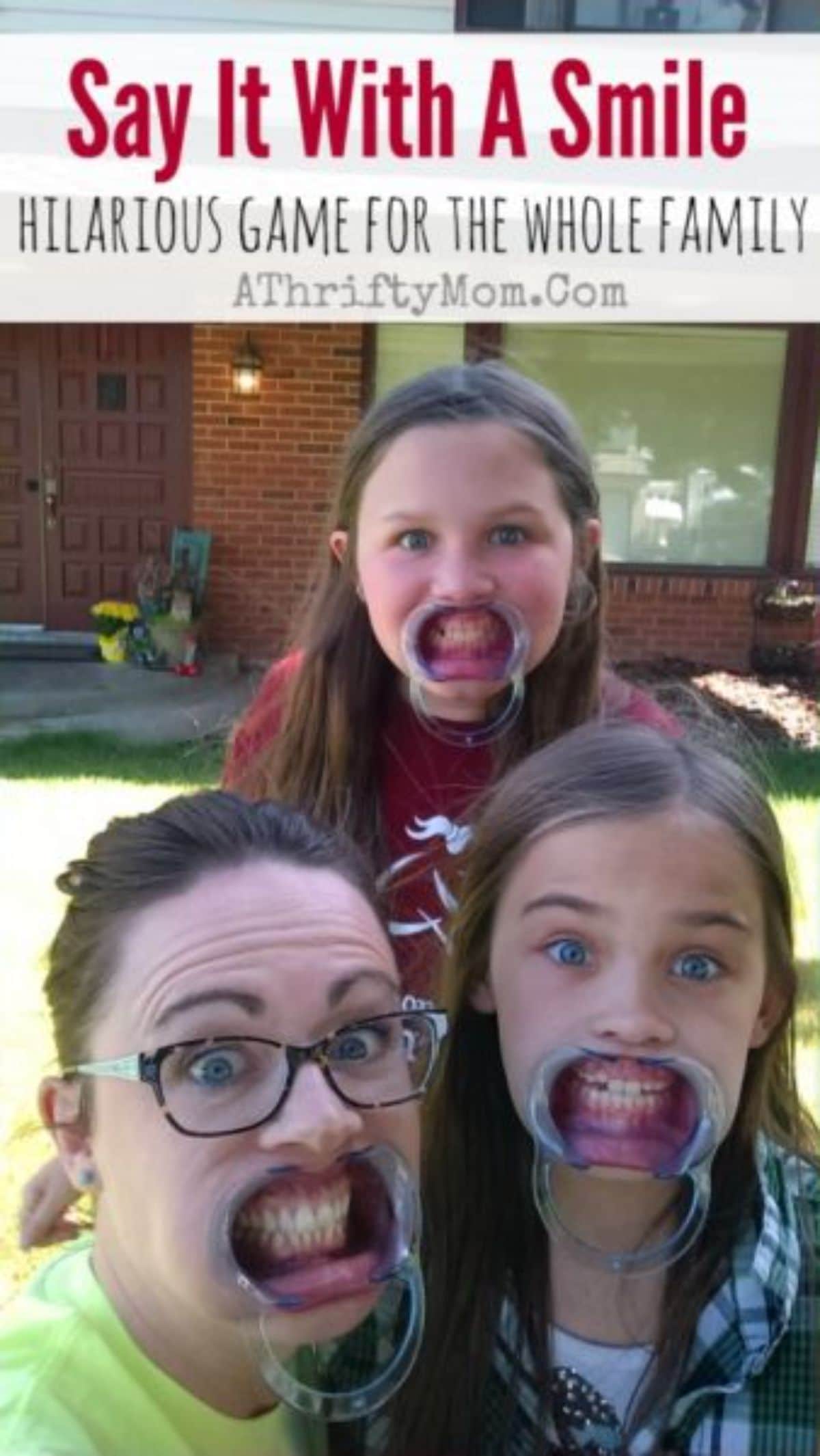 The text reads "Say it with a smile. Hilarious game for the whole family. AThriftyMom.com" The image is of 2 girls and a woman with retainers in their mouths