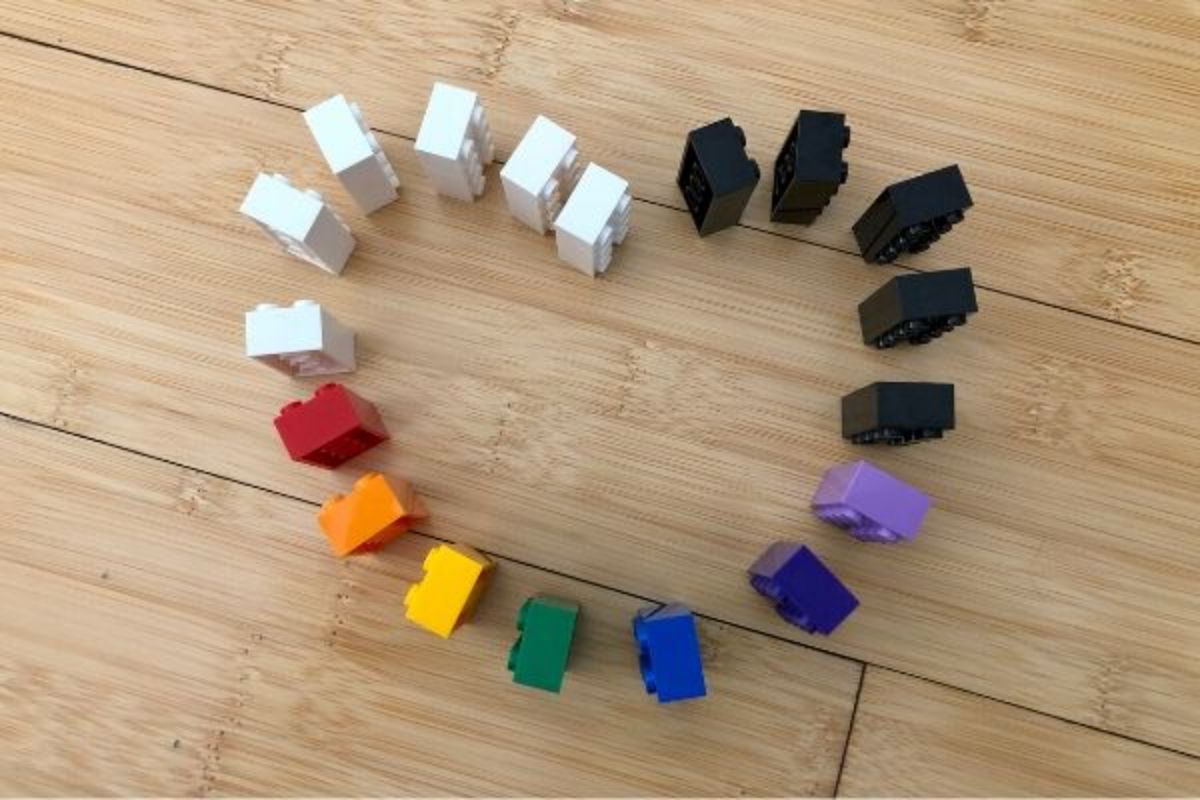 coloured lego bricks are arranged standing on their ends in a heart shape