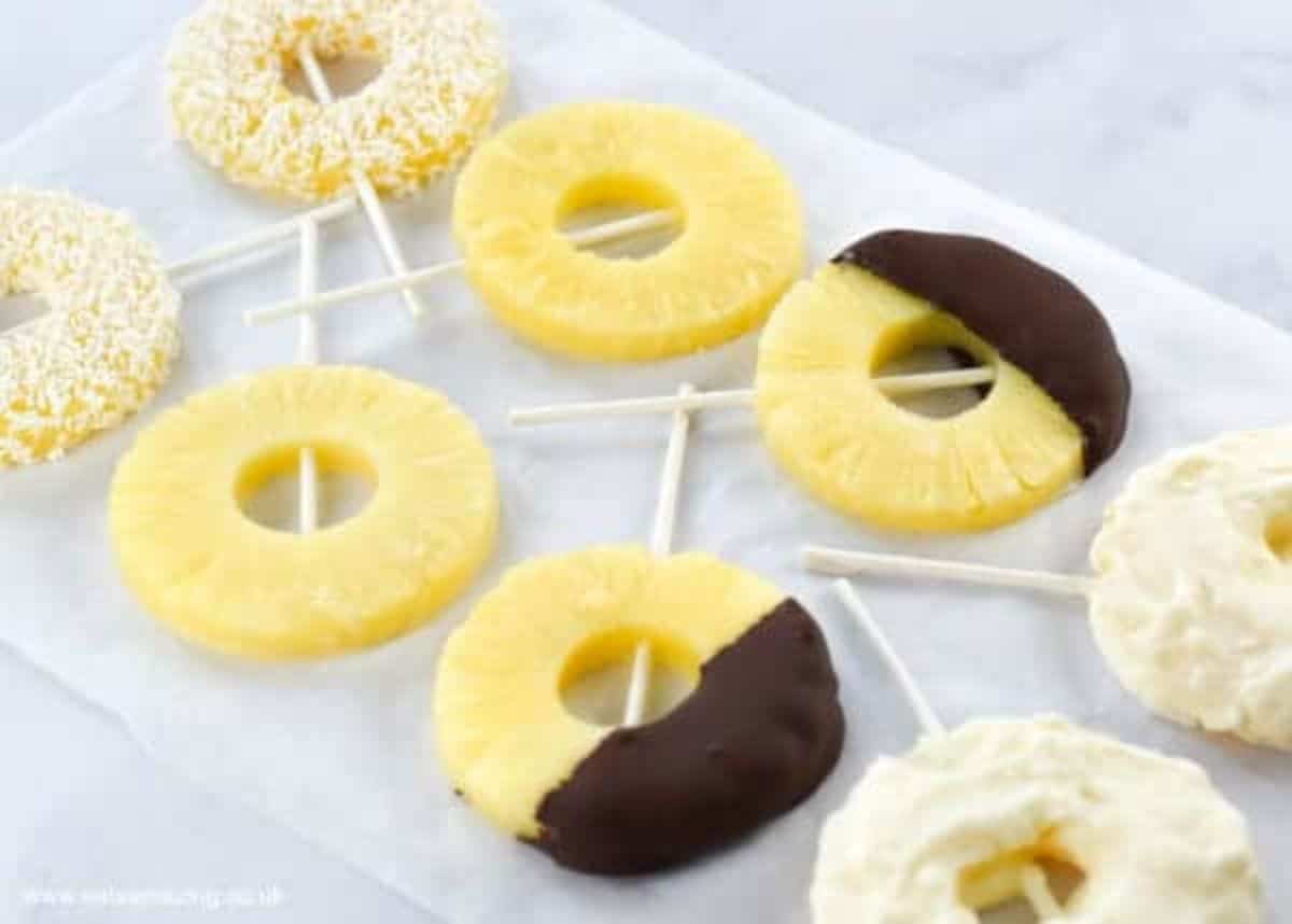 8 slices of pineapple are dipped in dark and white chocolate