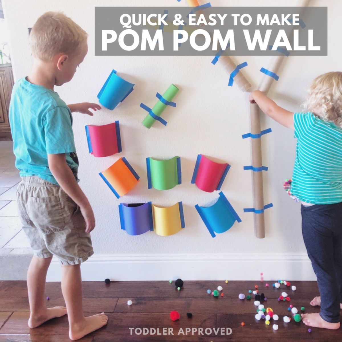 the text reads "Quick & Easy to make pom pom wall" the image s of 2 children standing in front of a wall. The wall has tubes of cardboard taped to it and pom poms are scattered over the floor