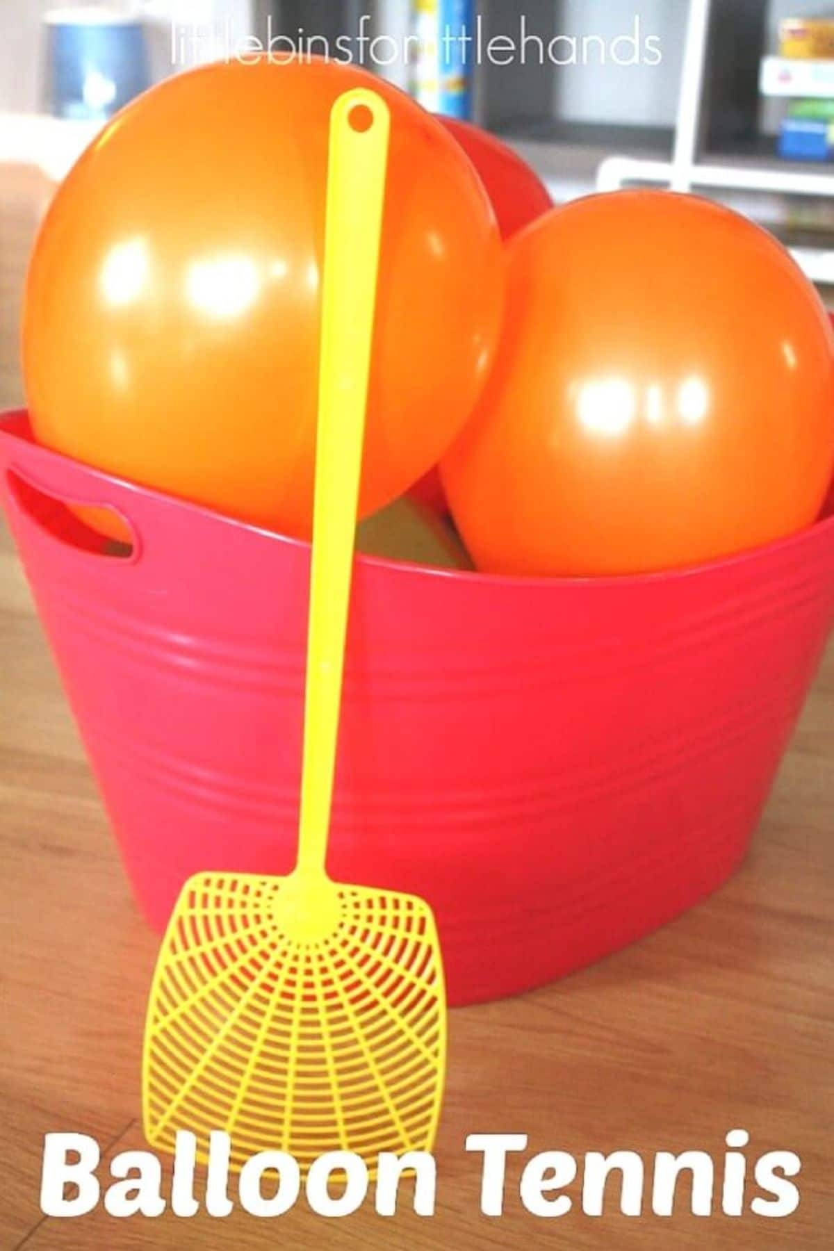 a red plastic basket with orange balloons in it. In front of it is a yellow fly swatter and the text "Balloon tennis"