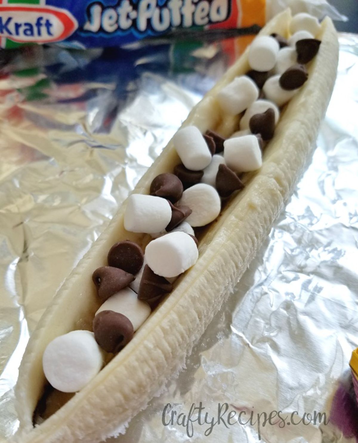 a banana split lengthways and filled with chocolate chips and mini marshmallows