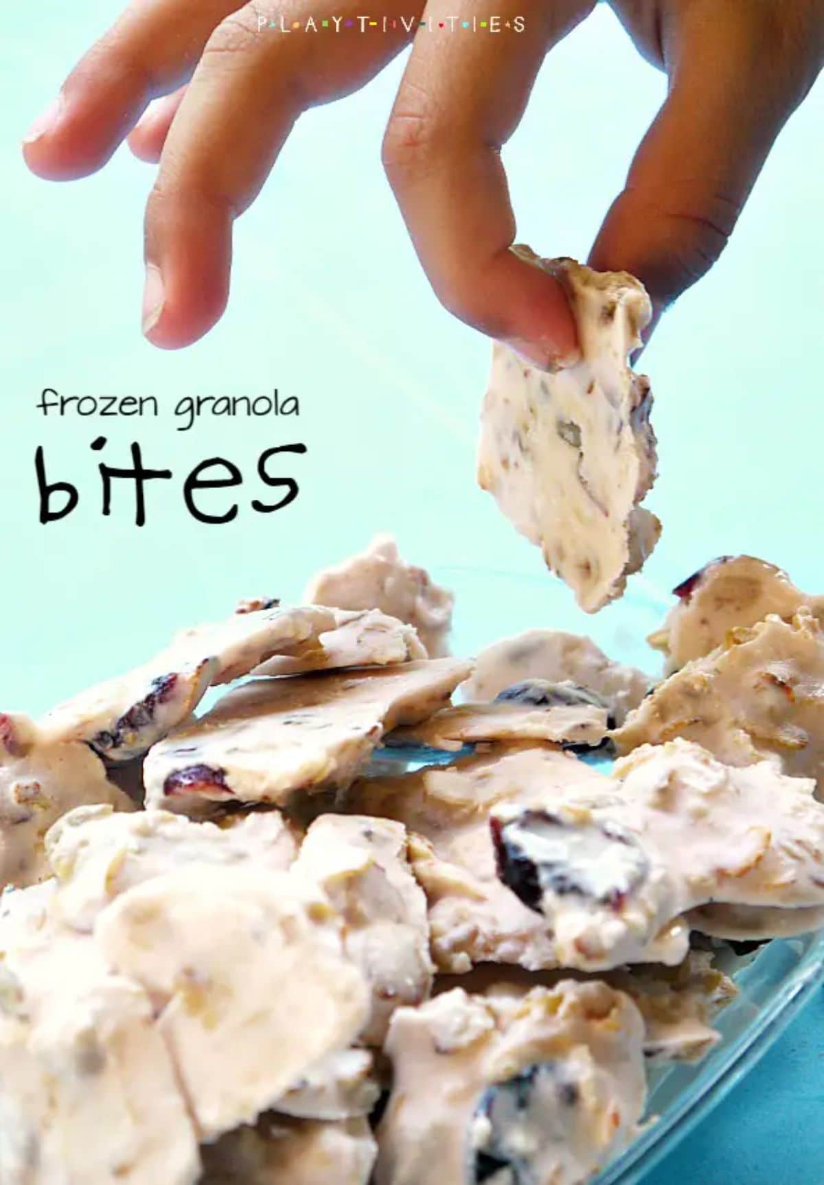 A hand picks out a yoghurt granols bite from a plate of bites The text reads "frozen granola bites"