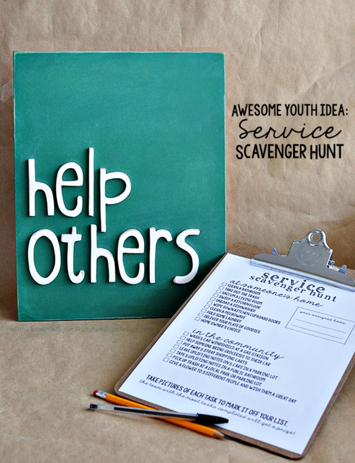 Against a brown background is a turquoise rectangular board with "help others" in raised white letters. Below is a sheet with writing on it sitting on a clipboard. A pen and a pencil are infront of the clipboard. Text to the right reads "Awesome youth idea: service scavenger hunt"