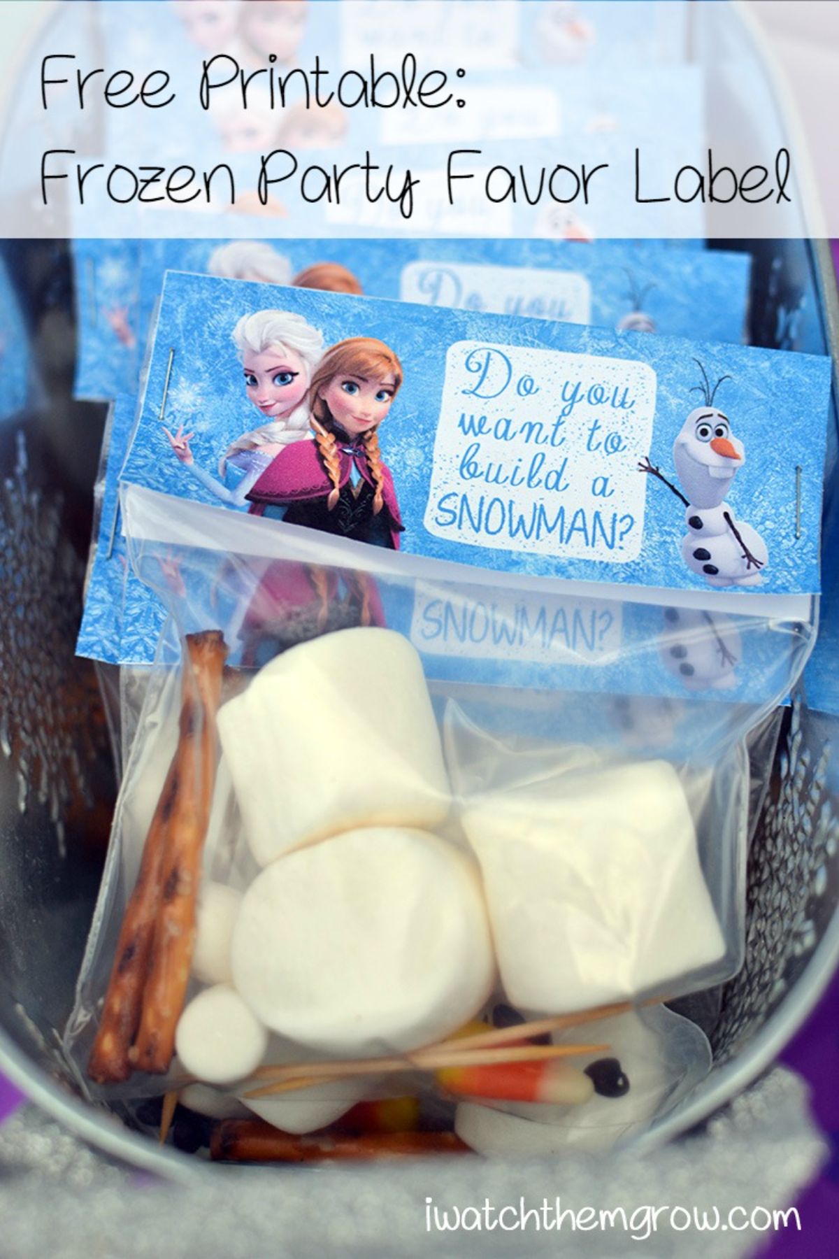 a basket of plastic parcels filled with marshmallows, twiglets and cocktails sticks. They are labelled "Do you want to bbuild a snowman" with Frozen disney characters on the label