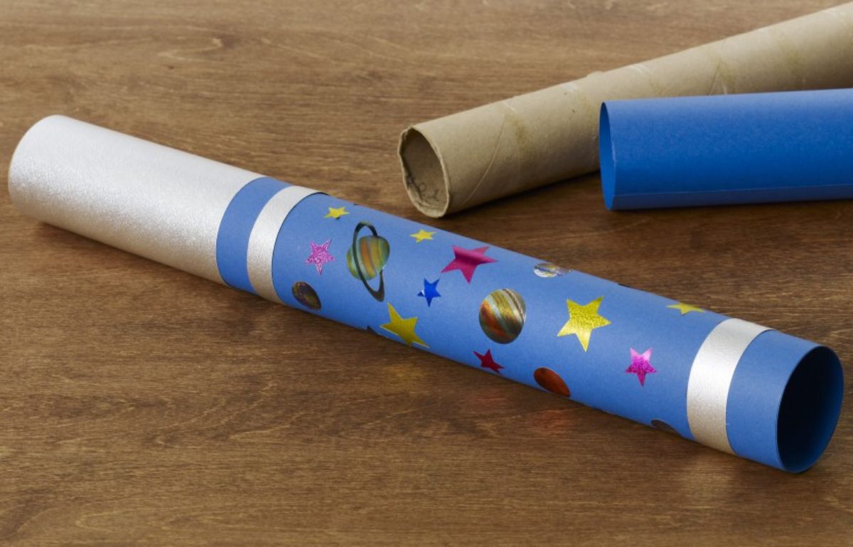 3 cardboard roll tubes are turned into telescopes decorated with stars and plnets