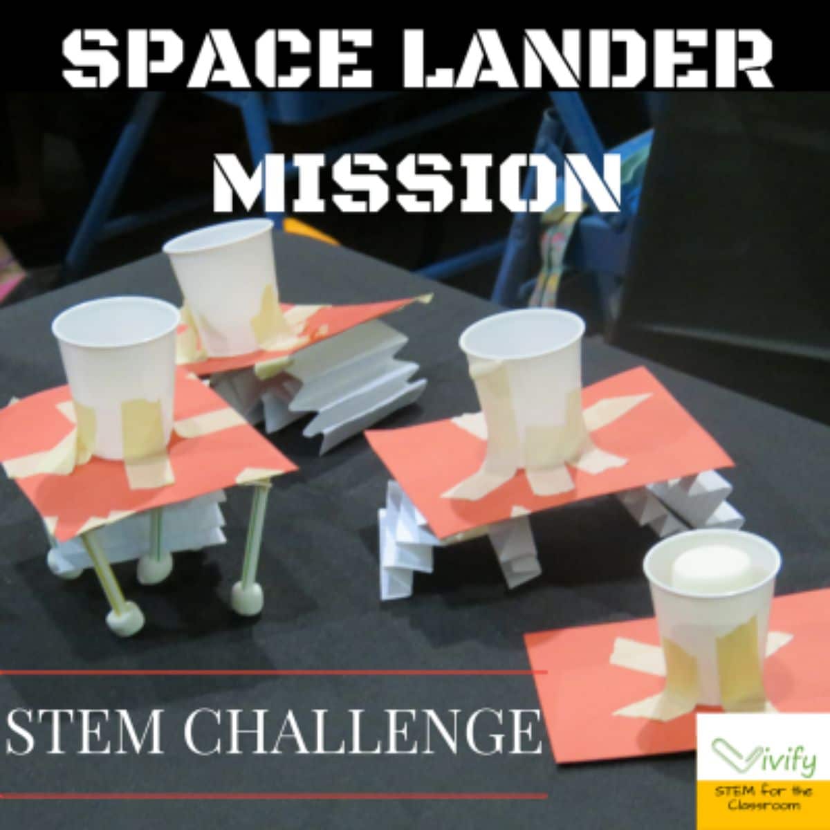 The text reads "Space Lander Mission STEM Challenge" the image is of space landers made out of card, cups and straws