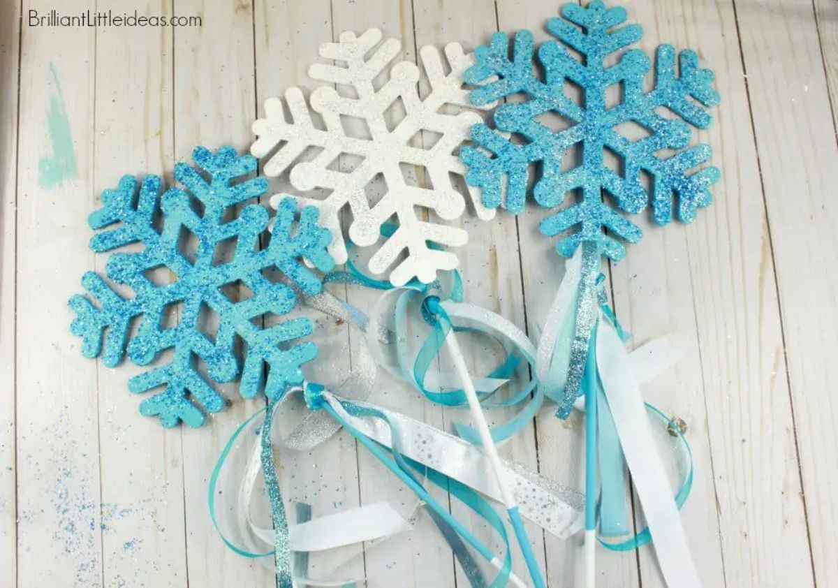 2 blue and 1 white snowflake wands with ribbons attached