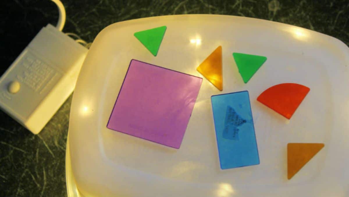a washing up bowl has been turned into a light box with colored perspex shapes on the top