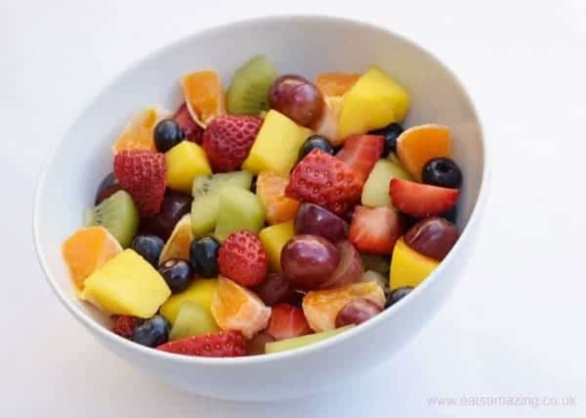 a white bowl filled with fruit salad