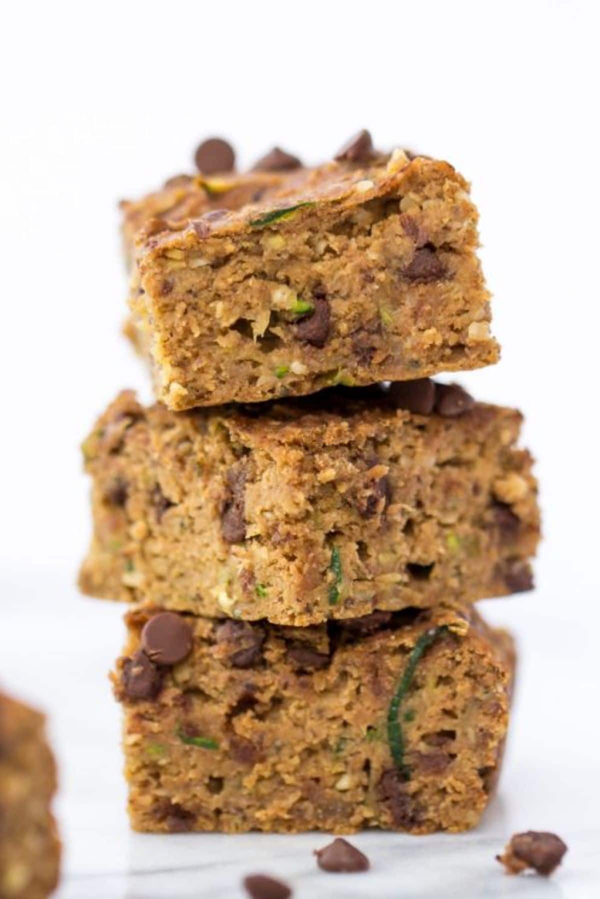 a stack of zucchini bars with scattered chocolate chips