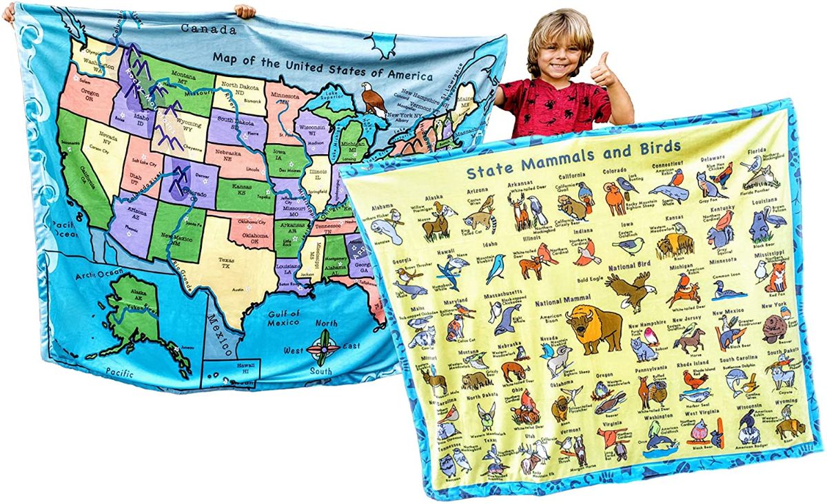 blonde boy holding up capital and state learning blanket