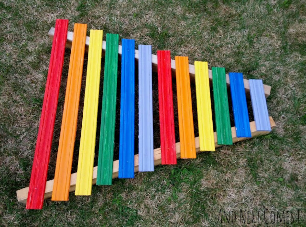 Homemade ranbow xylophone on a green grass.