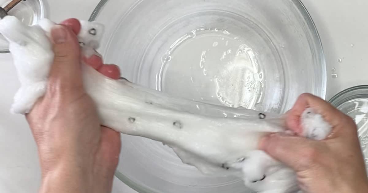 Penguin jelly Cube Slime being stretched over a bowl