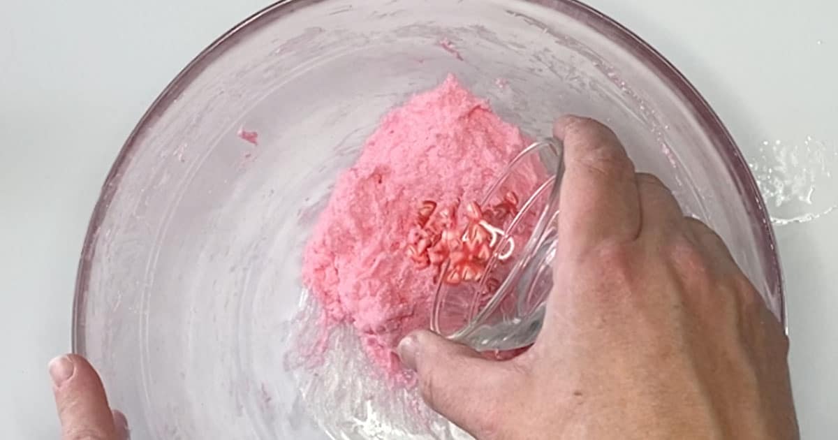 adding strawberry slime sprinkles to make Strawberry Milkshake Slime