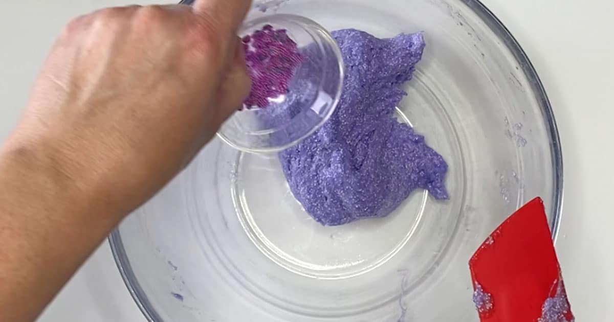 in-process image of adding slime sprinkles to grape slushy slime
