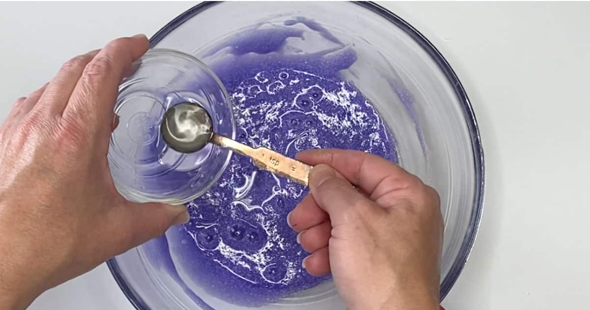 in-process step of adding activator to make grape slushie slime