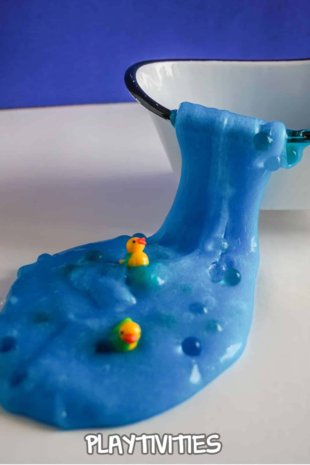 rubber ducky slime spilling out of a tiny bathtub